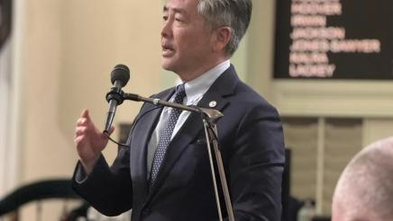 Asm. Muratsuchi standing at microphone on the Assembly Floor, speaking