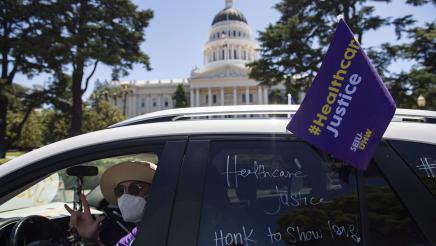 Supporter driving by in SUV with sign