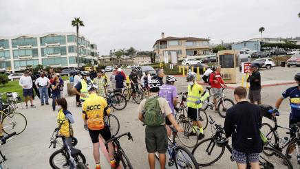 People on bikes congregated in a parking lot