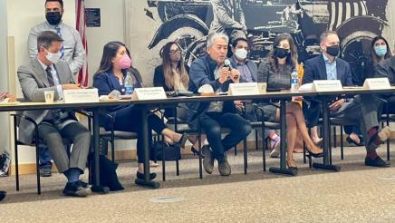 Asm. Muratsuchi at table with other panelists, speaking