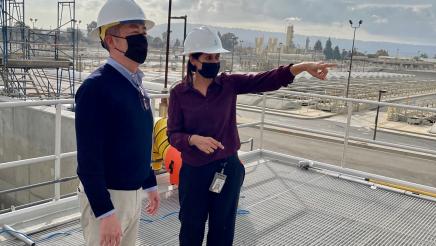 Tour guide gestures while Asm. Muratsuchi listens on