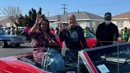 Asm. Muratsuchi sitting in back of parade car with Wanda Love