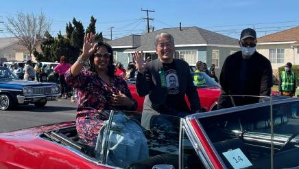 Asm. Muratsuchi sitting in back of parade car with Wanda Love