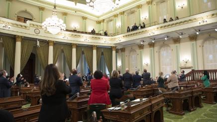 Assemblymembers applauding guests