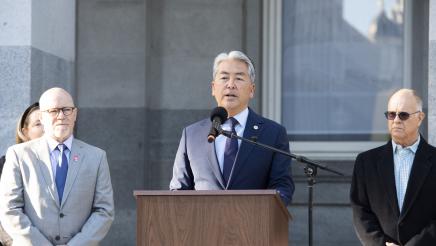 Assemblymember Muratsuchi stands at a podium to announce his bill to address retail theft