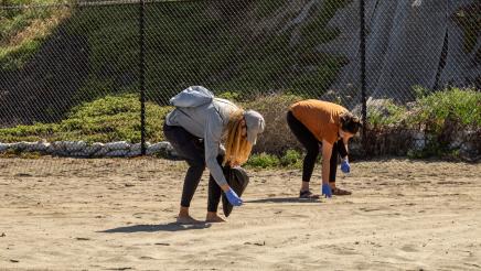 Two volunteers removing debris