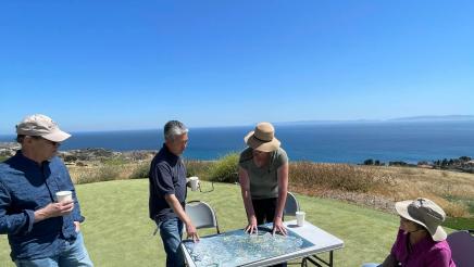 Asm. Muratsuchi viewing map on table with conservancy members