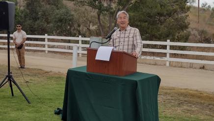 Asm. Muratsuchi at podium, speaking