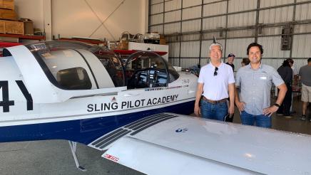 Asm. Muratsuchi posing alongside plane
