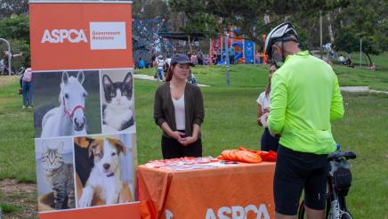 ASPCA booth staffers providing information to constituent