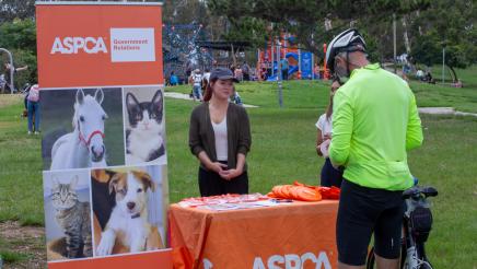 ASPCA booth staffers providing information to constituent