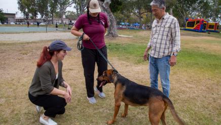 Booth staffers care for dog as Asm. Muratsuchi looks on