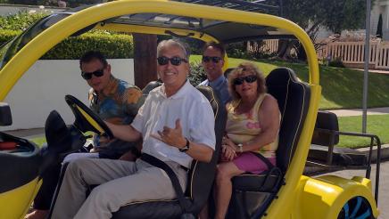Asm. Muratsuchi with city officials, driving through neighborhood in a Neighborhood Electric Vehicle