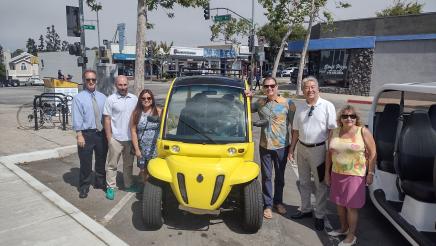 Asm. Muratsuchi and city officials posing with a Neighborhood Electric Vehicle