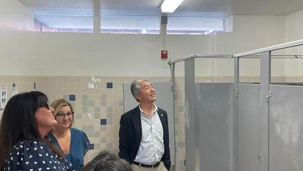 Asm. Muratsuchi and school staff inspecting restroom ceiling