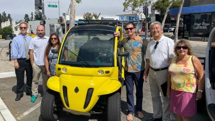 Asm. Muratsuchi and city officials posing with a Neighborhood Electric Vehicle