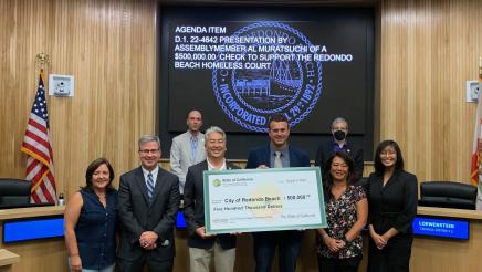 Assembly Al Muratsuchi stands with the City of Redondo leaders with a big novelty check of $500,000 for the City of Redondo Homeless Court Program 
