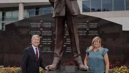 Asm. Muratsuchi standing alongside monument