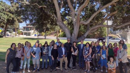 Assemblymember Al Muratsuchi stands with a group for a group photo in Manhattan Beach. 