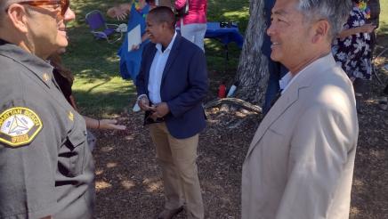 Assemblymember Al Muratsuchi speaks with a Law Enforcement Officer. 