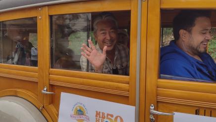 Asm. Muratsuchi riding in classic vehicle, waving