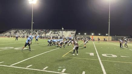 Football players on field at night
