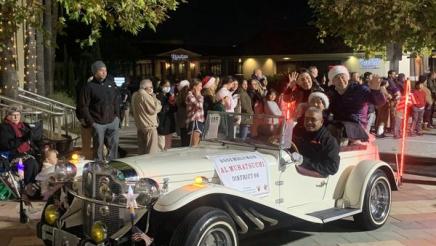 Asm. Muratsuchi and familty sitting high in back seat of parade car