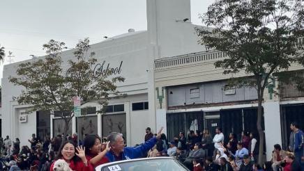 Asm. Muratsuchi and familty sitting high in back seat of car, on parade route