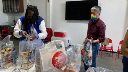 Asm. Muratsuchi carrying bags; volunteer packing bags