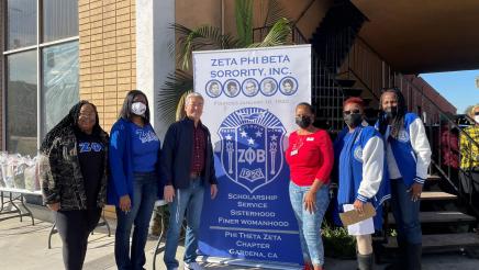 Asm. Muratsuchi with Zeta Phi Beta Sorority, Inc. members standing in front of banner