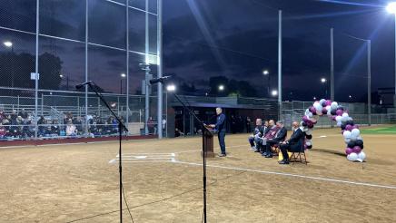 Asm. Muratsuchi at podium in front of home base, speaking to attendees