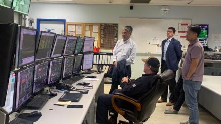 Asm. Muratsuchi and plant staff inside control room, viewing multiple screens