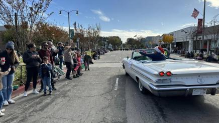 Rear view of car, with Asm. Muratsuchi waving to constituents