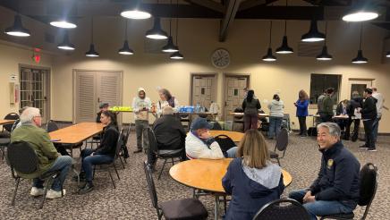 Volunteers waiting at tables and signing in