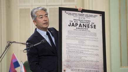 Asm. Muratsuchi holding up a framed statement from the U.S. Army