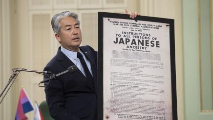 Asm. Muratsuchi holding up a framed statement from the U.S. Army