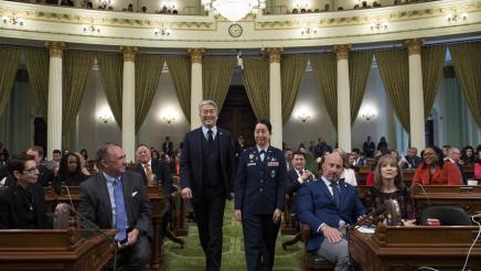 Asm. Muratsuchi escorting Colonel Mia L. Walsh on the Assembly Floor
