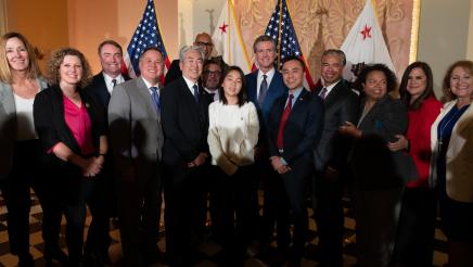 Asm. Muratsuchi with his daughter, Gov. Newsom and other members