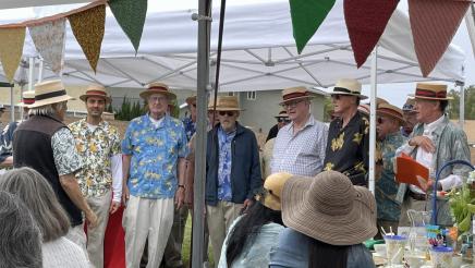 Multiple fundraiser attendees standing in line, singing