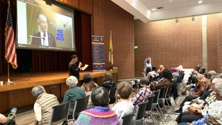 Senior Scam Stopper attendees, with Asm. Muratsuchi's website displayed on large screen