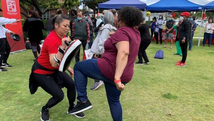 Senior engaged in combat practice with instructor