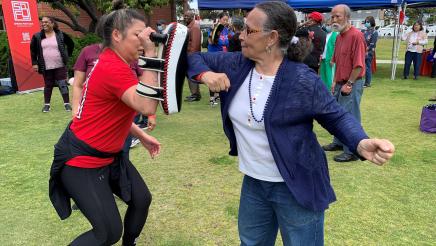 Senior engaged in combat practice with instructor