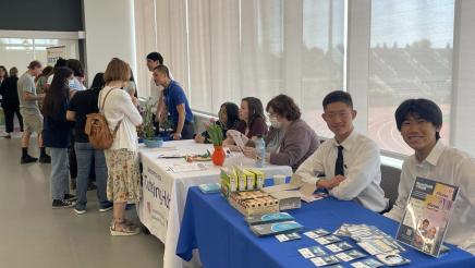 Staff at tables with informational materials