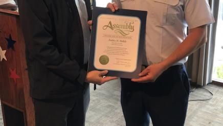 Asm. Muratsuchi presenting Petty Officer Andres Pulido with an award