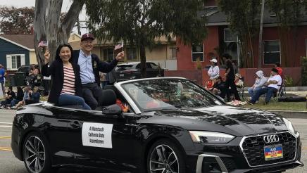 Asm. Muratsuchi and wife sitting high in backseat of parade car