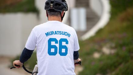 Asm. Muratsuchi on bike, wearing "Muratsuchi 66" jersey