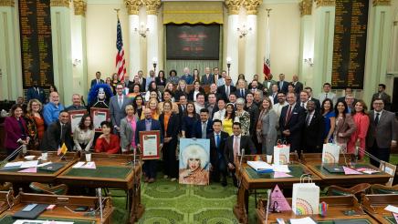 Group photo of assemblymembers and activists on the Assembly Floor