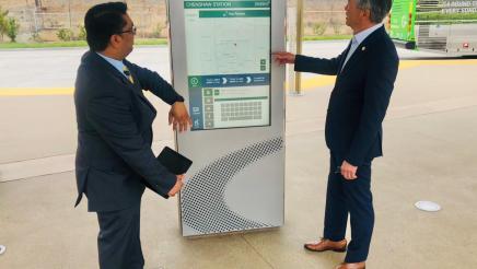 Asm. Muratsuchi examining an electronic kiosk