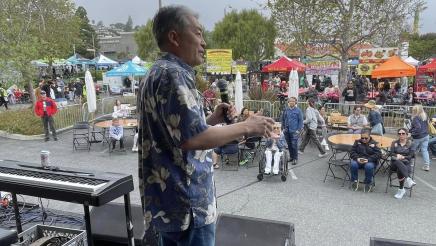 Asm. Muratsuchi onstage, speaking to attendees