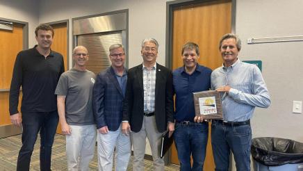 Group photo of Asm. Muratsuchi and attendees, displaying Redondo Beach plaque